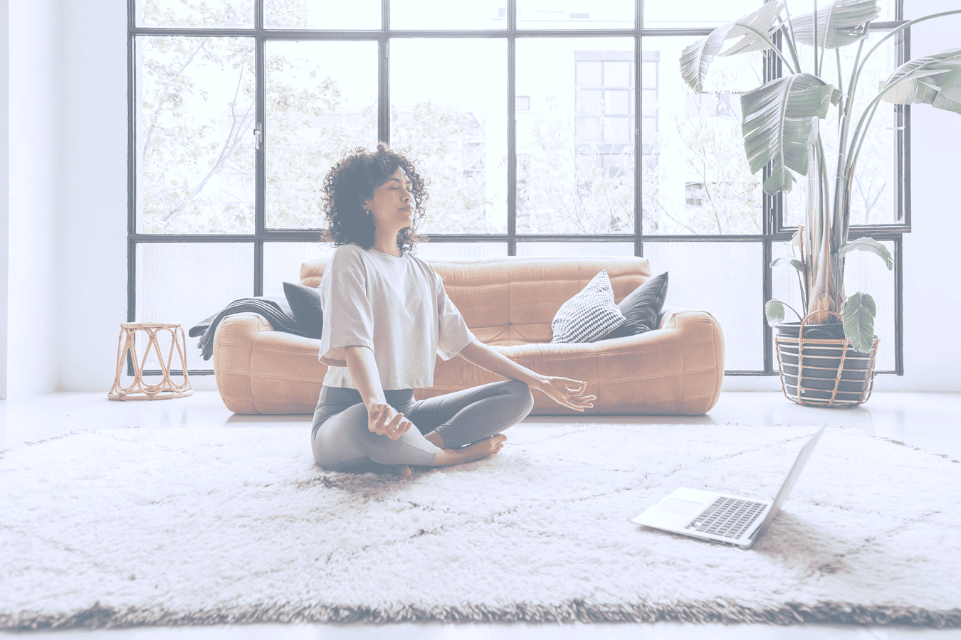 Woman meditating in a cozy living room