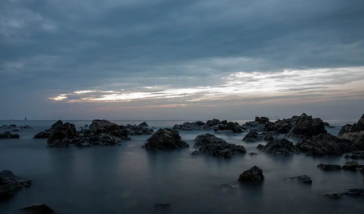 Tranquil sea with scattered rocks